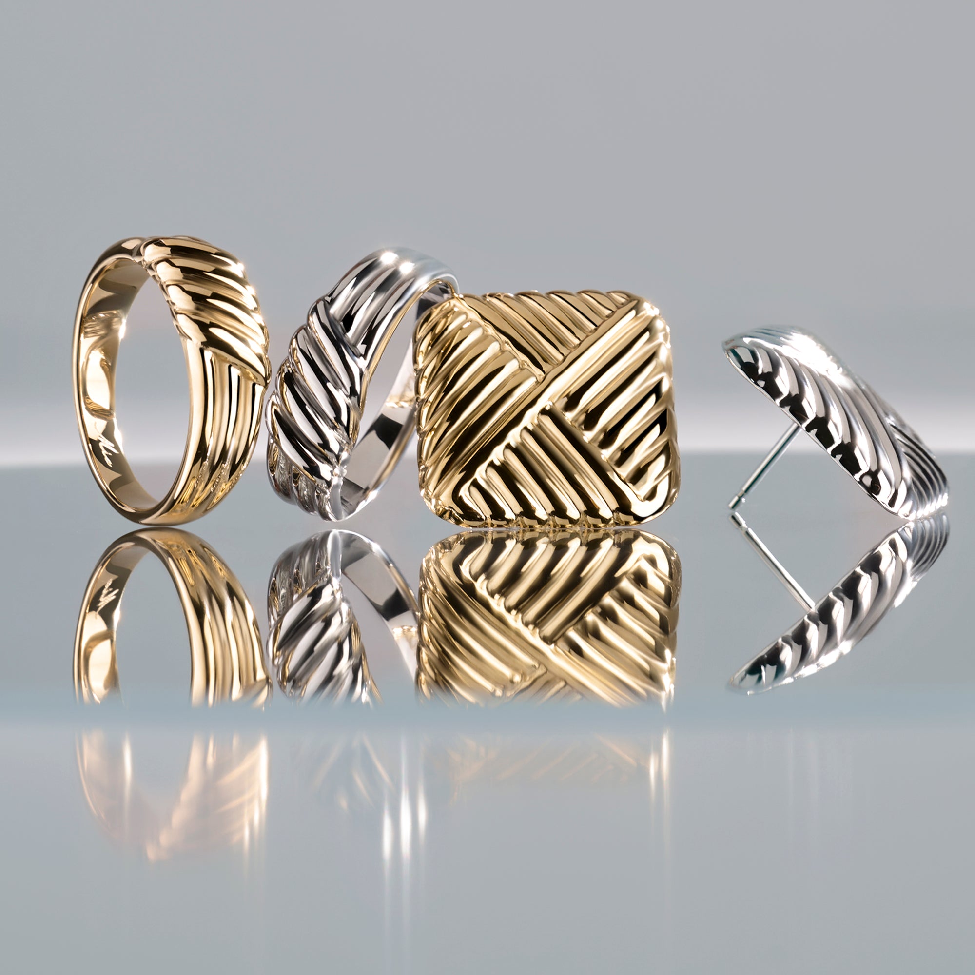 Gold and silver stainless steel textured rings and stud earrings with woven sculptural design, bold modern jewelry set, hypoallergenic non-tarnish durable jewelry, elegant contemporary statement jewelry.
